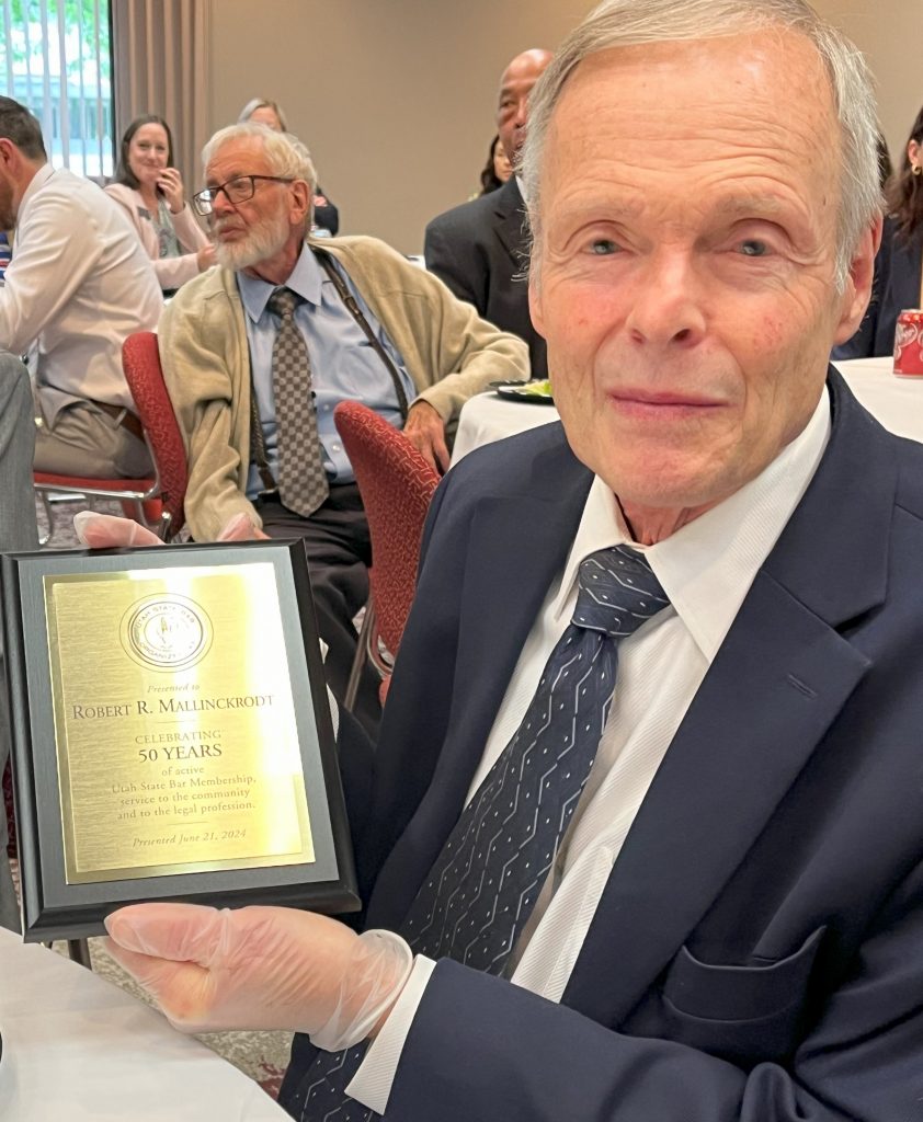 Robert R. Mallinckrodt shows his plaque he received for giving 50 yeras of service to the legal profession